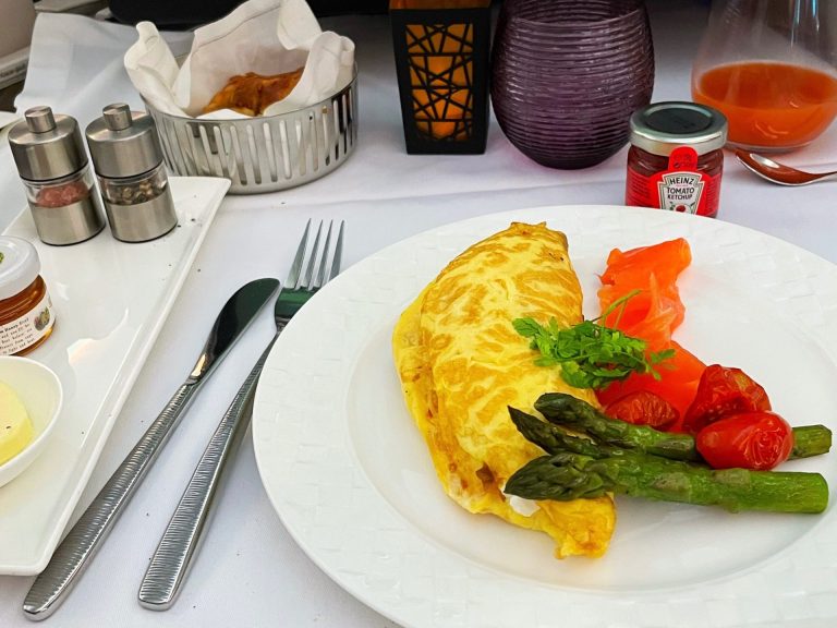 Egg, asparagus, and tomato on a plate.