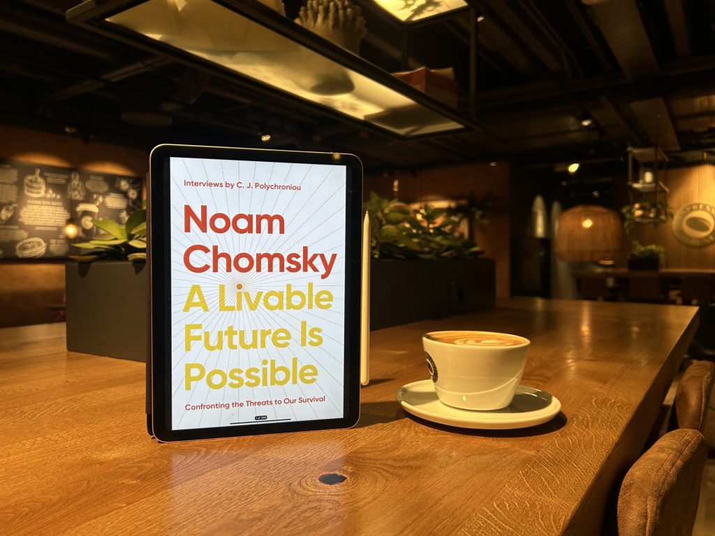 A Liveable Future Is Possible eBook with a cup of coffee.