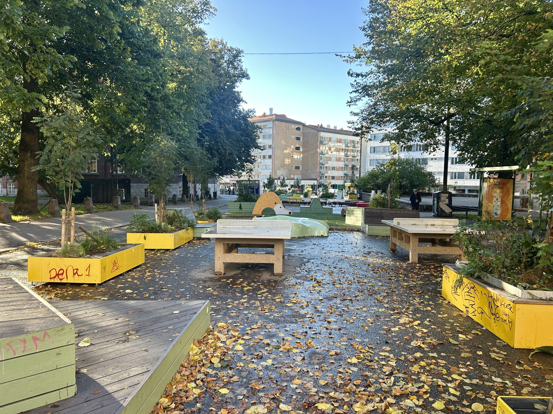 A street converted into a summer park with chairs and a ping-pong table.
